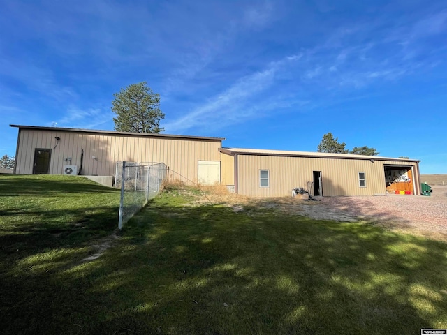 rear view of property with a yard