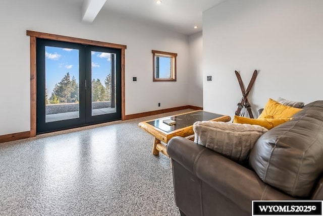 living room with beamed ceiling and french doors