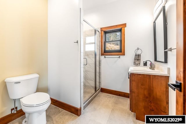 bathroom featuring vanity, a shower with shower door, and toilet