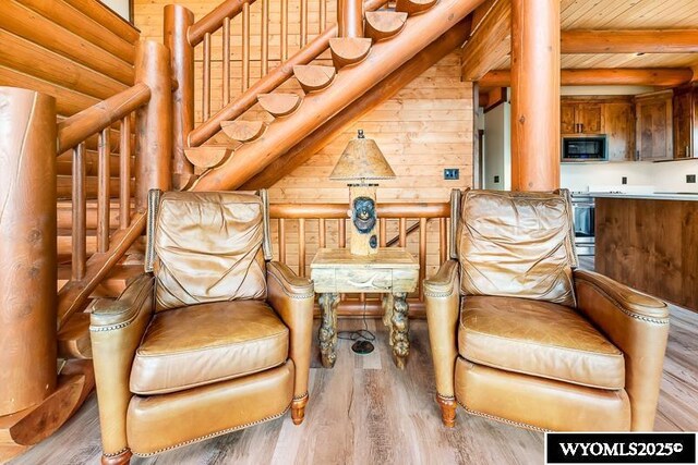 sitting room with vaulted ceiling with beams, light hardwood / wood-style flooring, and wooden ceiling