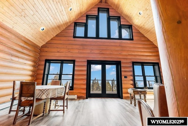 interior space with hardwood / wood-style flooring, wooden ceiling, high vaulted ceiling, and baseboard heating