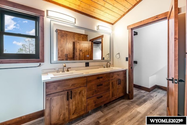 bathroom with wood ceiling, crown molding, vaulted ceiling, vanity, and hardwood / wood-style floors