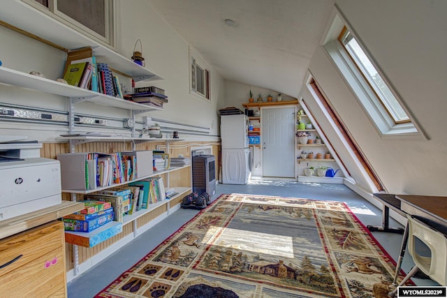 recreation room featuring lofted ceiling with skylight and dark colored carpet