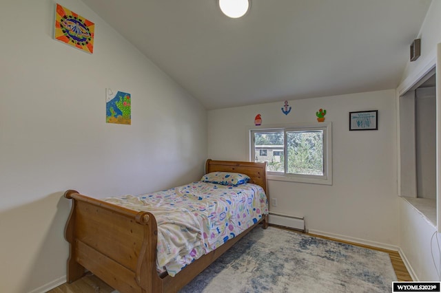 bedroom featuring a closet, lofted ceiling, wood-type flooring, and baseboard heating