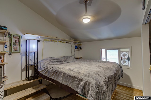 bedroom featuring vaulted ceiling and wood-type flooring