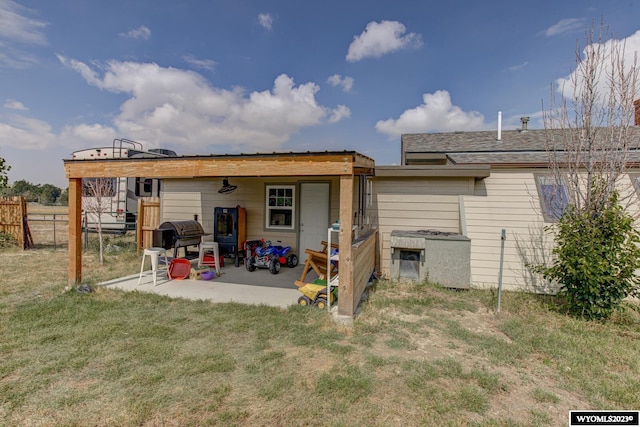 rear view of property with a lawn and a patio