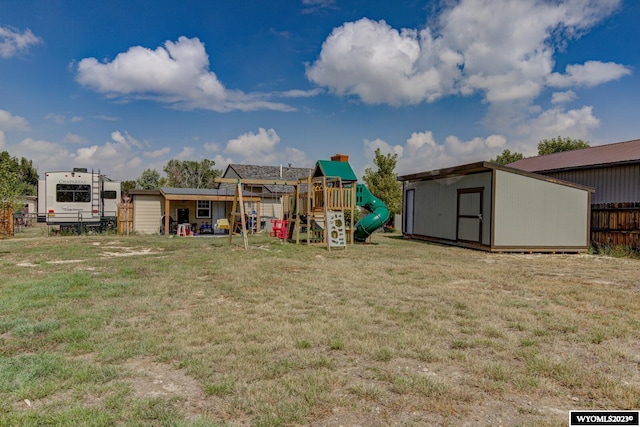 view of yard featuring a playground and a shed