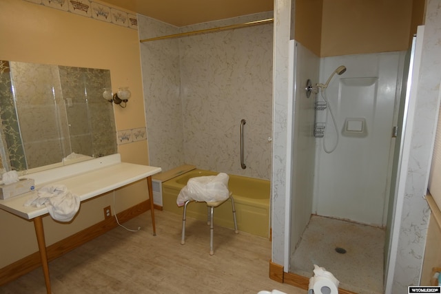 bathroom featuring hardwood / wood-style floors and walk in shower