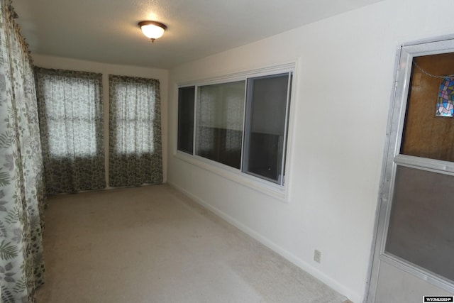 interior space featuring a textured ceiling and carpet