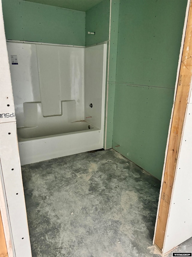 bathroom with shower / bathing tub combination and concrete flooring