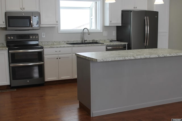 kitchen with white cabinetry, sink, and stainless steel appliances