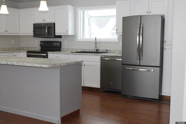 kitchen with sink, white cabinets, pendant lighting, and appliances with stainless steel finishes