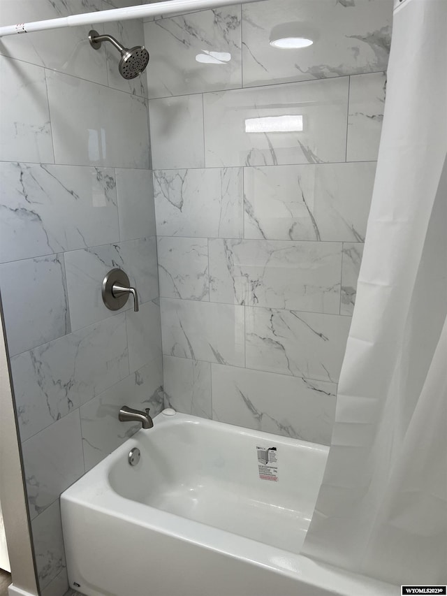 bathroom with shower / bath combination with curtain