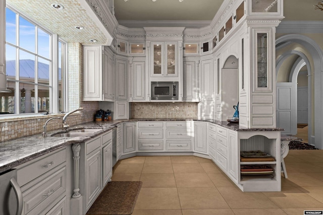 kitchen featuring appliances with stainless steel finishes, sink, dark stone countertops, white cabinets, and a mountain view