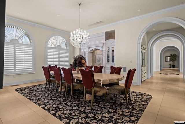 dining area featuring light tile patterned flooring, ornamental molding, and a notable chandelier