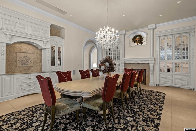 dining room featuring an inviting chandelier, crown molding, and light tile patterned floors