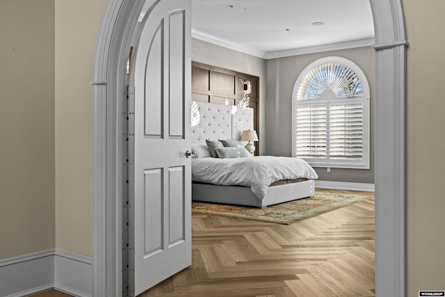 bedroom with ornamental molding and light parquet flooring