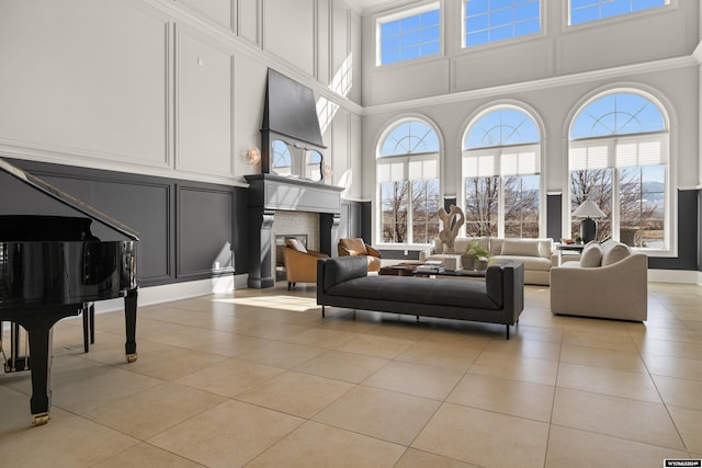 tiled living room featuring a high ceiling