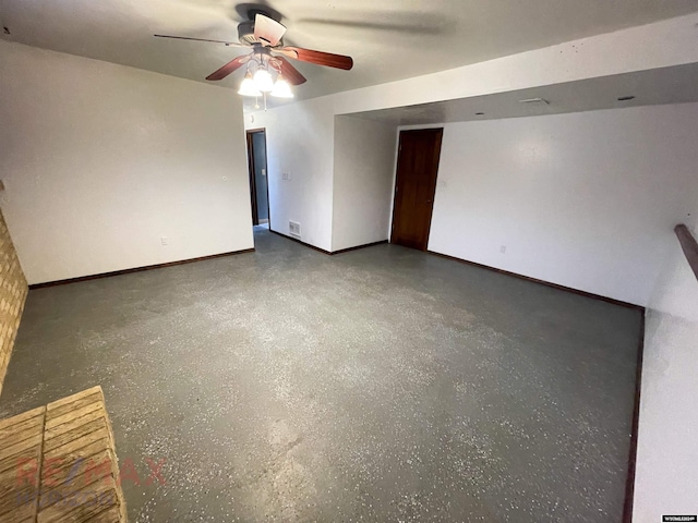 unfurnished room with ceiling fan, baseboards, and speckled floor