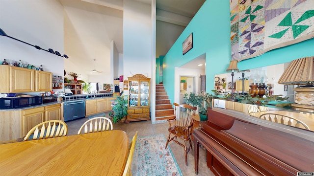 dining space featuring sink, high vaulted ceiling, and light tile patterned floors