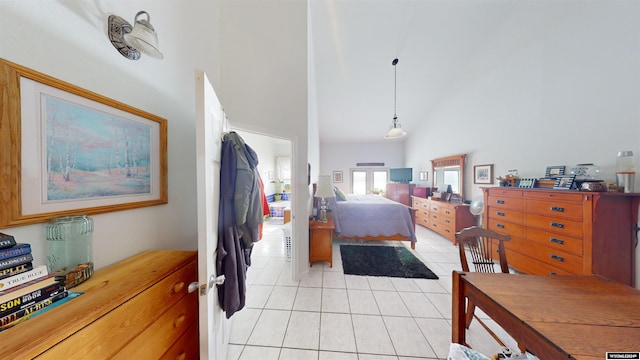 bedroom with high vaulted ceiling and light tile patterned flooring