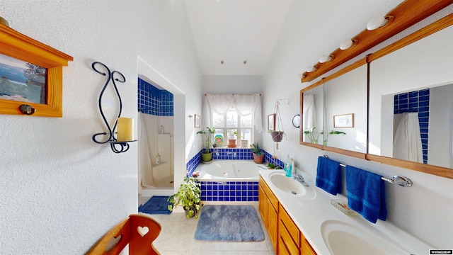 bathroom with plus walk in shower, vanity, tile patterned flooring, and vaulted ceiling