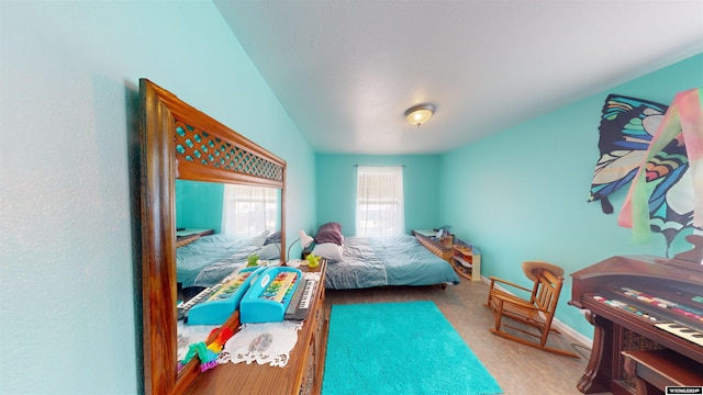 carpeted bedroom featuring lofted ceiling