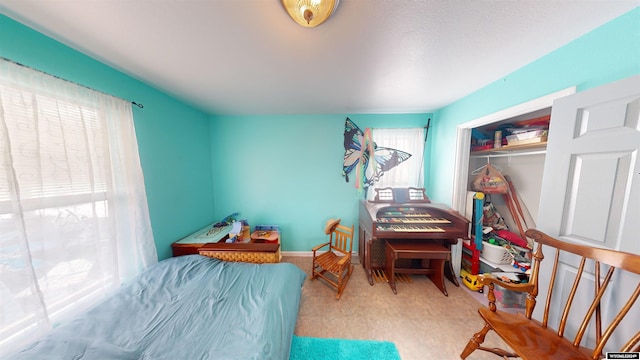 bedroom with light carpet and a closet