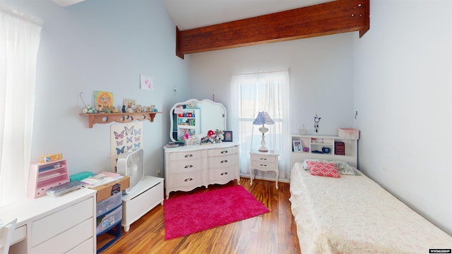 bedroom with beamed ceiling and light hardwood / wood-style flooring