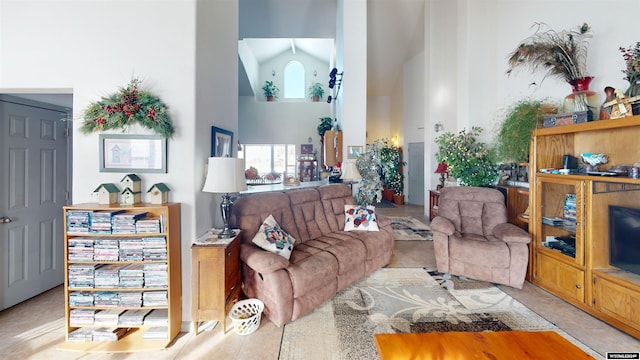 living room with high vaulted ceiling