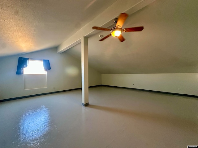 bonus room with a textured ceiling and lofted ceiling with beams