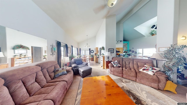 living room with high vaulted ceiling and an inviting chandelier