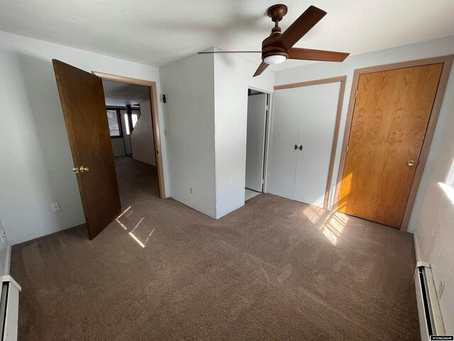 unfurnished bedroom featuring light carpet, a baseboard radiator, and ceiling fan