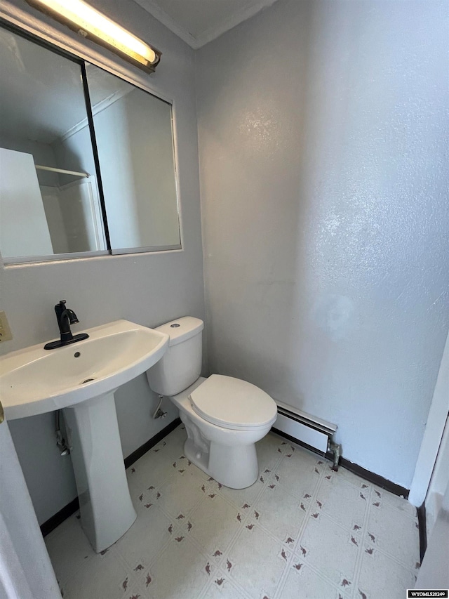 bathroom with tile floors, a baseboard radiator, and toilet