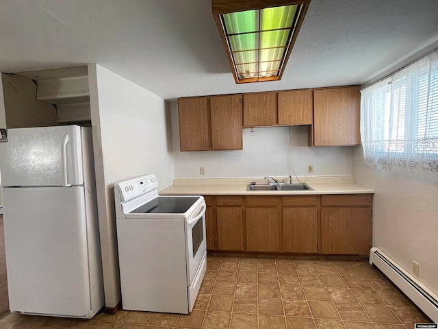 kitchen with light tile flooring, sink, white appliances, and a baseboard heating unit