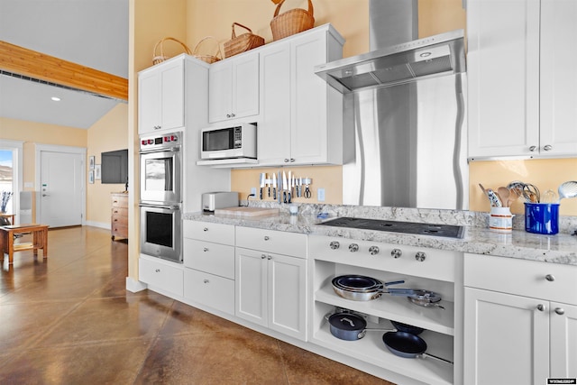 kitchen featuring white cabinetry, double oven, dark tile floors, light stone counters, and wall chimney exhaust hood