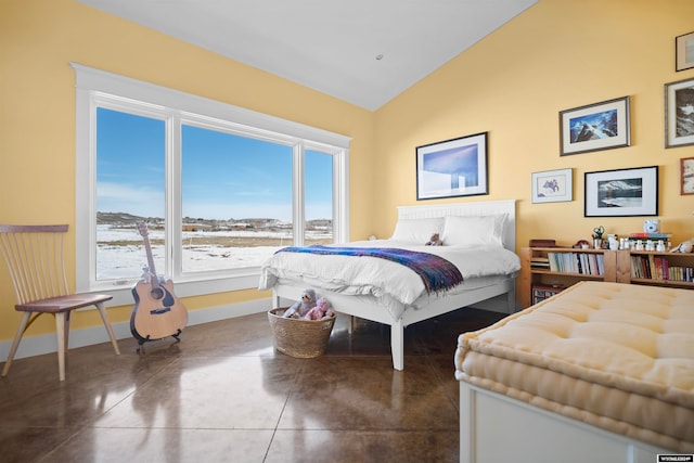 bedroom featuring tile flooring and vaulted ceiling