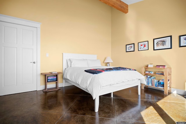 tiled bedroom featuring a high ceiling and beamed ceiling