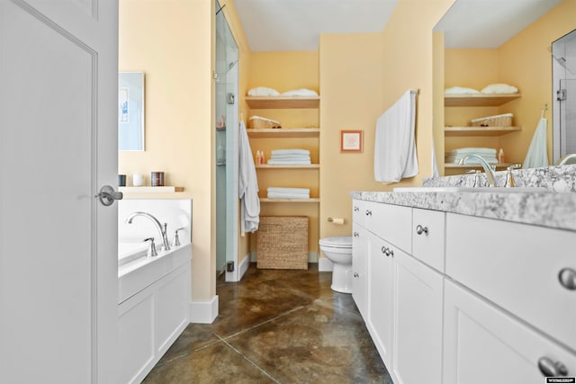 bathroom featuring a bath to relax in, tile floors, vanity with extensive cabinet space, and toilet