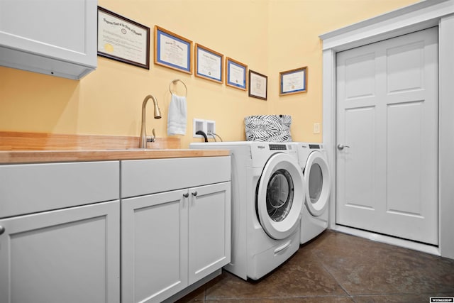 laundry room with sink, cabinets, dark tile flooring, and independent washer and dryer