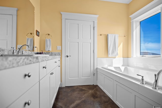 bathroom featuring a bathing tub, tile floors, and vanity