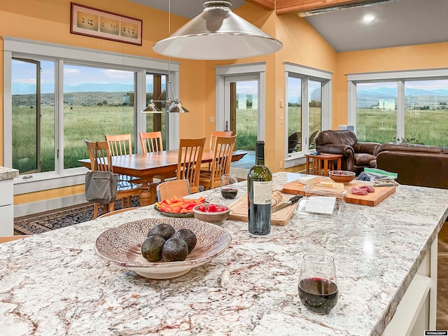 interior space with vaulted ceiling with beams and a mountain view