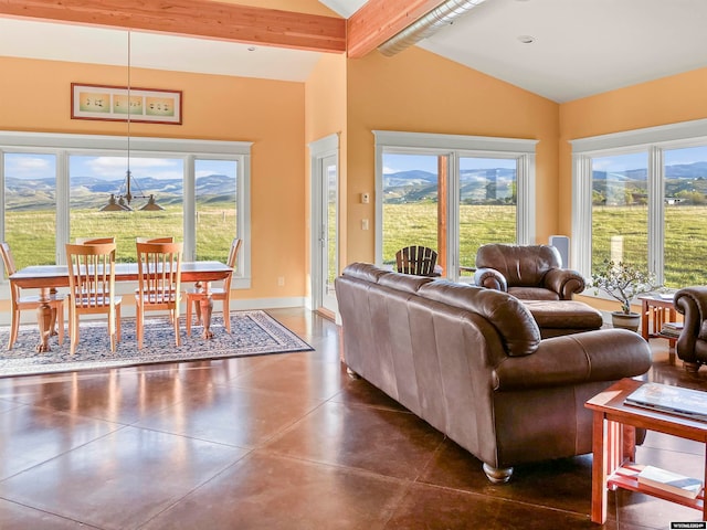 living room with lofted ceiling with beams, dark tile flooring, and a mountain view