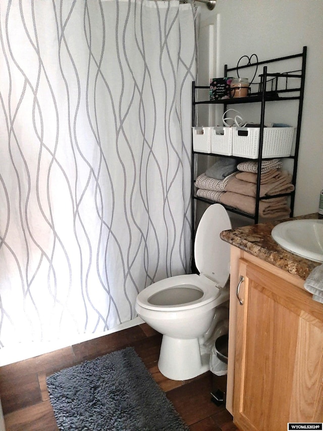 bathroom featuring hardwood / wood-style floors, vanity, and toilet