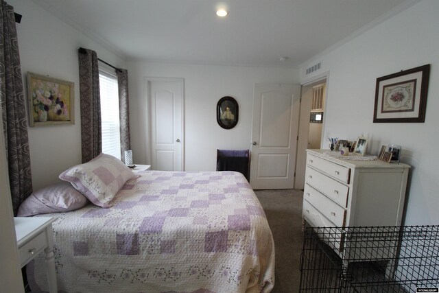 bedroom featuring dark colored carpet and crown molding