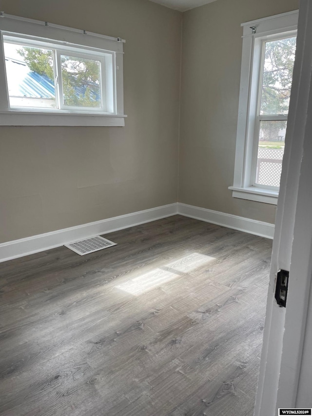 unfurnished room with dark wood-type flooring