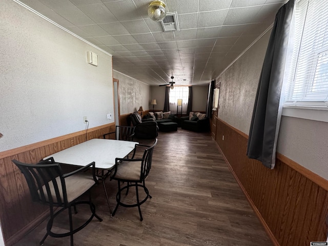 dining space with ceiling fan, ornamental molding, and dark wood-type flooring