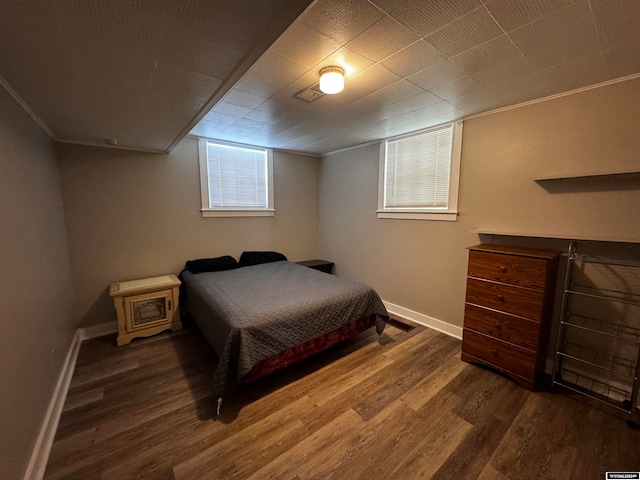 bedroom with dark hardwood / wood-style flooring