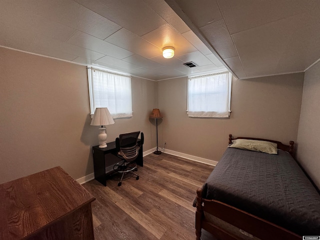 bedroom with dark wood-type flooring