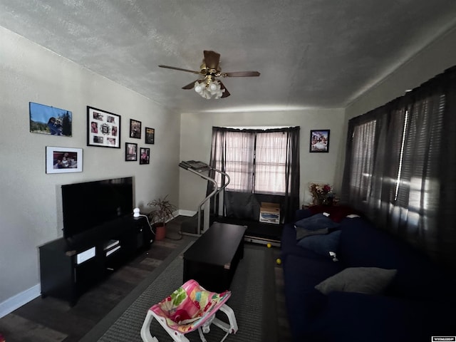 living room featuring a textured ceiling and ceiling fan